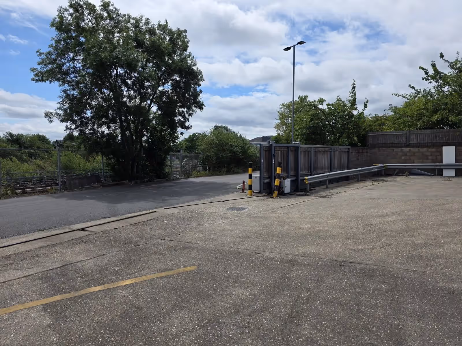Industrial sliding gate and vehicle barrier illustrating a multi-system commercial estate